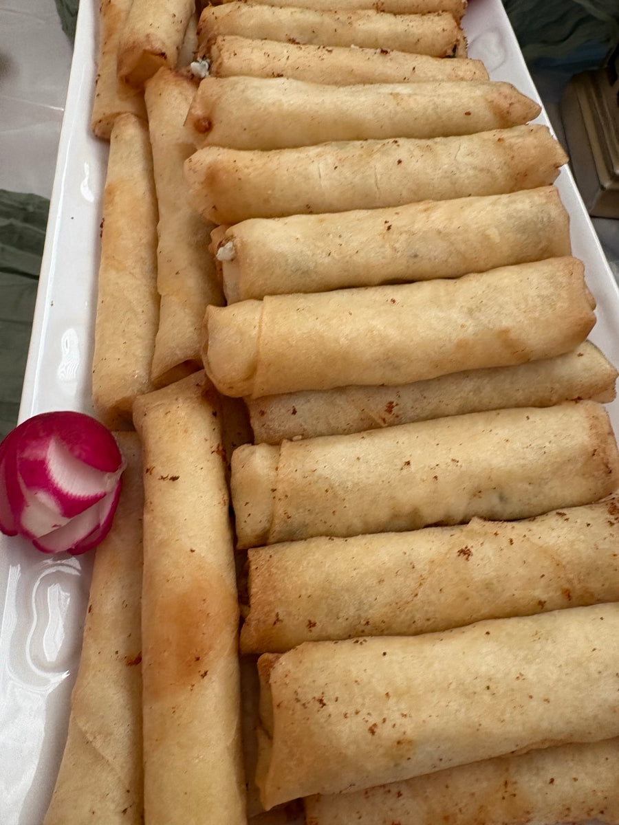 Golden pastry rolls arranged on a catering tray
