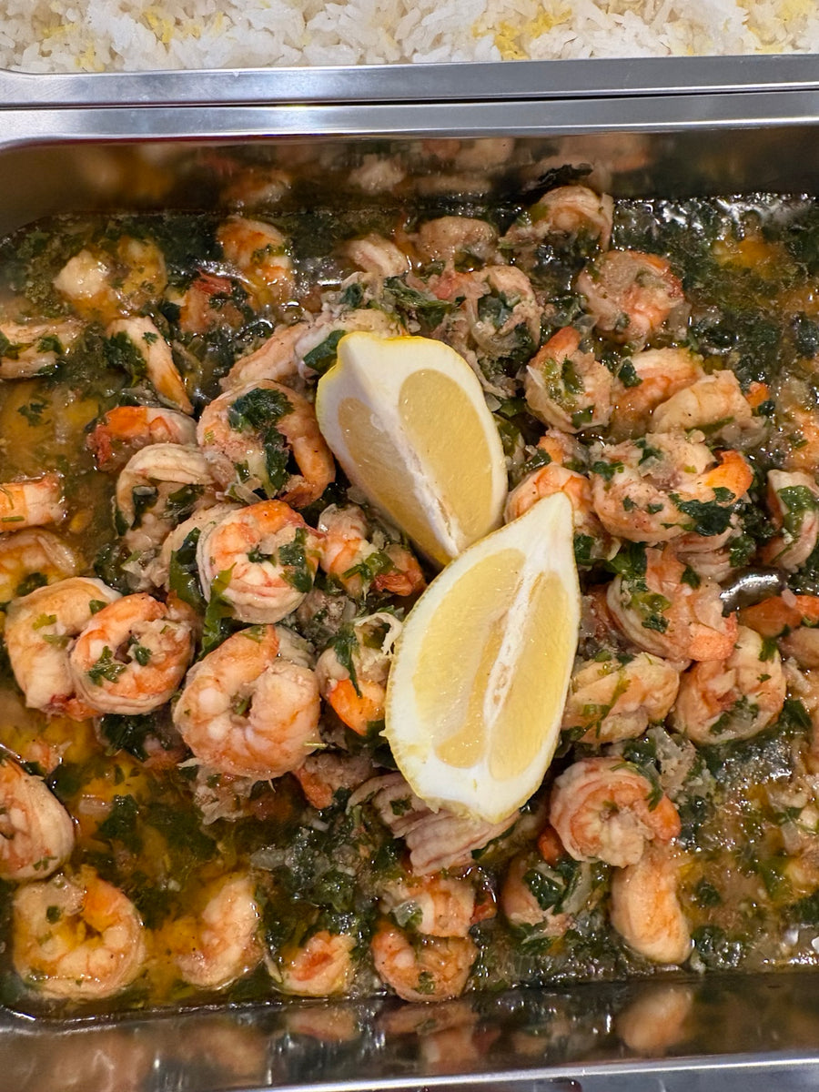 Shrimp platter with herbs and lemon wedges